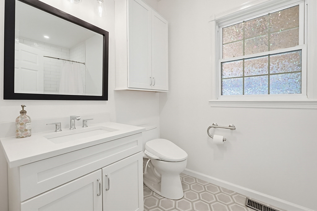 11 Broken Tree Road Medway, MA 02053 - Photo 16 of 42 a bathroom with a toilet sink and mirror