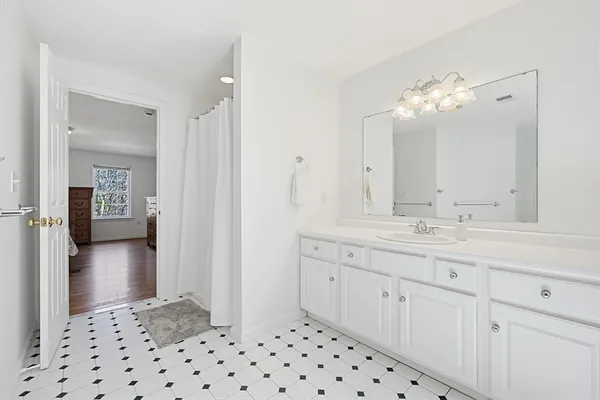 a bathroom with a sink vanity and a mirror