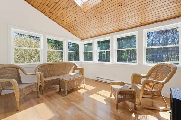 a living room with furniture and floor to ceiling windows