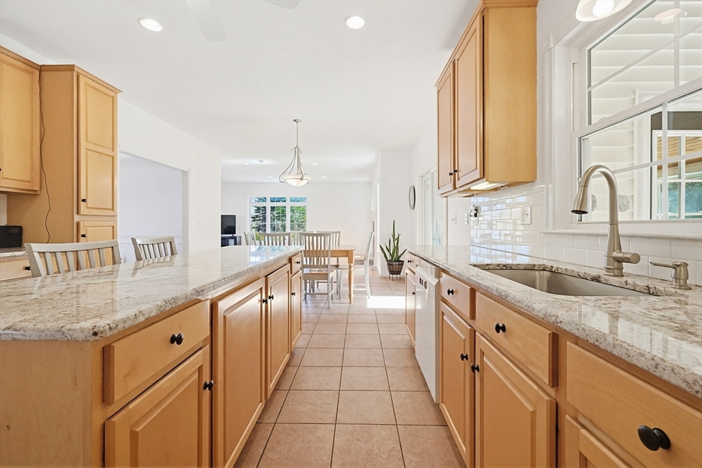 11 Broken Tree Road Medway, MA 02053 - Photo 5 of 42 a large kitchen with granite countertop a sink and a counter top space