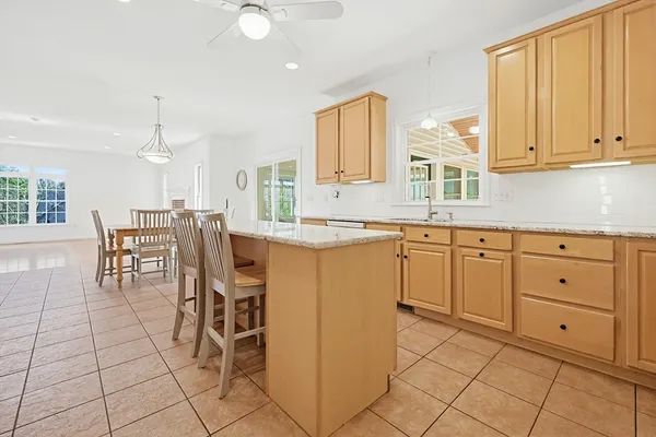 a kitchen with cabinets and chairs
