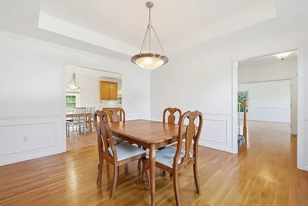 a dining room with furniture and wooden floor