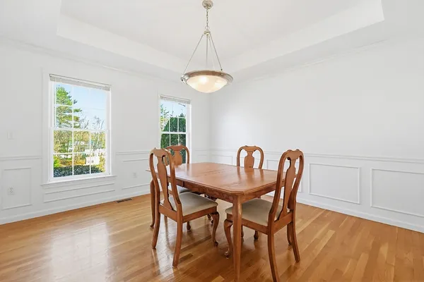 a view of a dining room with furniture window and wooden floor