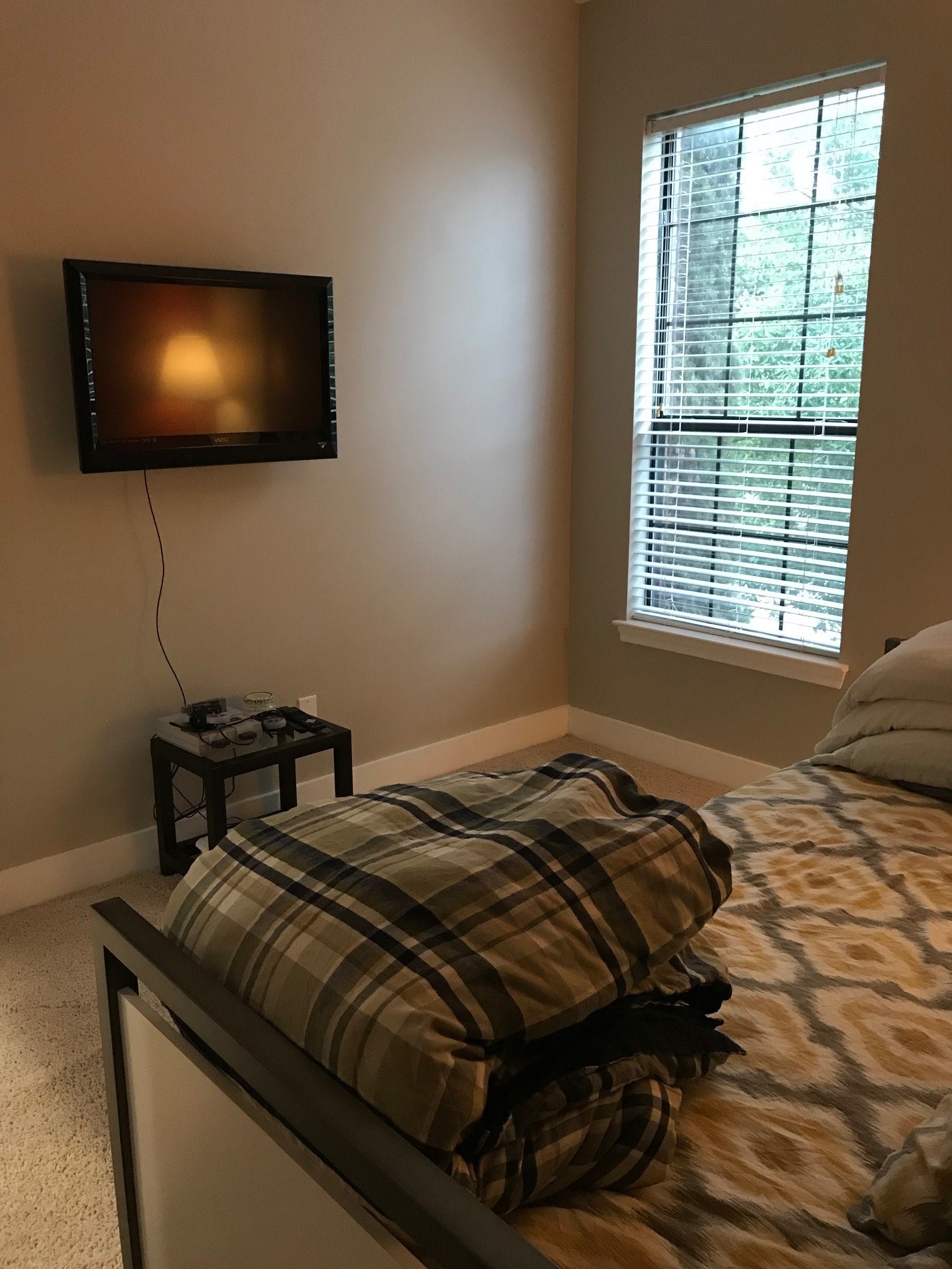 1414 Emancipation Avenue, Unit A Houston, TX 77003 - Photo 13 of 22 a bedroom with a bed and a flat screen tv