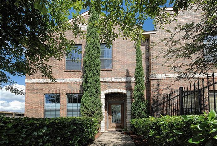 1414 Emancipation Avenue, Unit A Houston, TX 77003 - Photo 21 of 22 a front view of a house with plants and trees