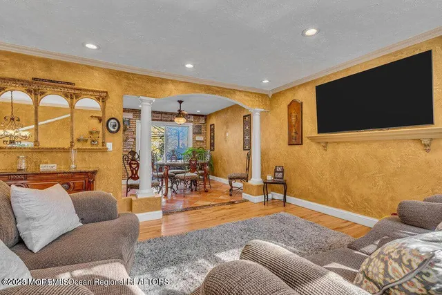 a bedroom with furniture and a flat screen tv