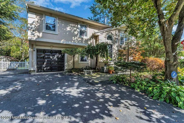 a view of a house with a yard and garage