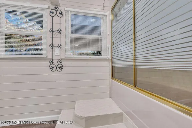 a bathroom with a bathtub and shower