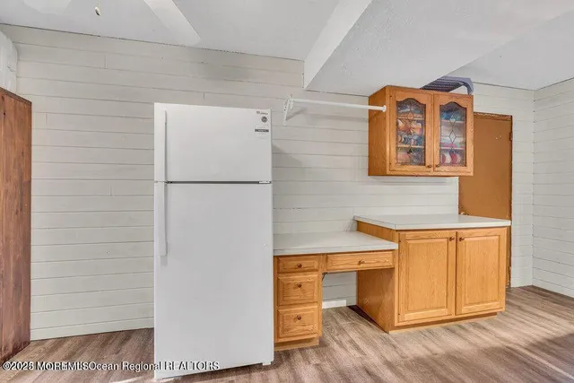 a utility room with closet and wooden floor