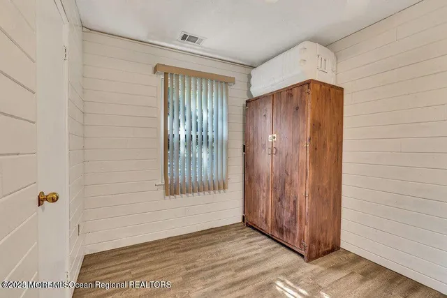 a view of walk in closet with wooden floor
