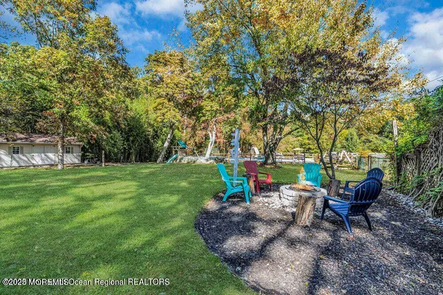 a view of a backyard with sitting area and garden