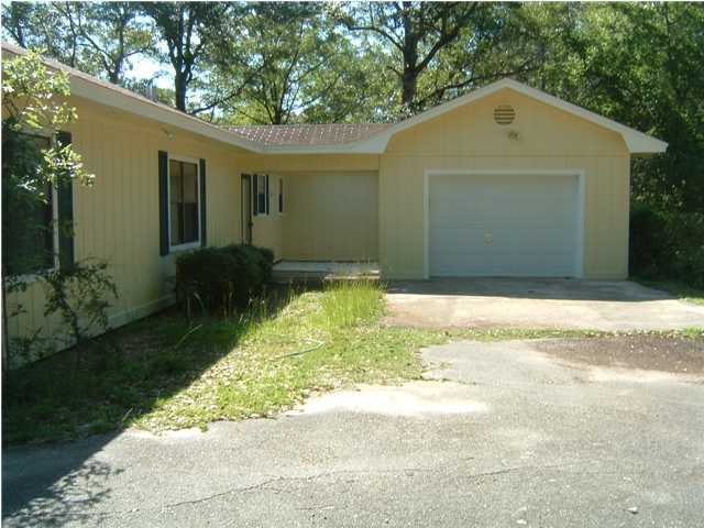 6151 Donald Guy Road Crestview, FL 32539 - Photo 3 of 24 a front view of a house with a yard