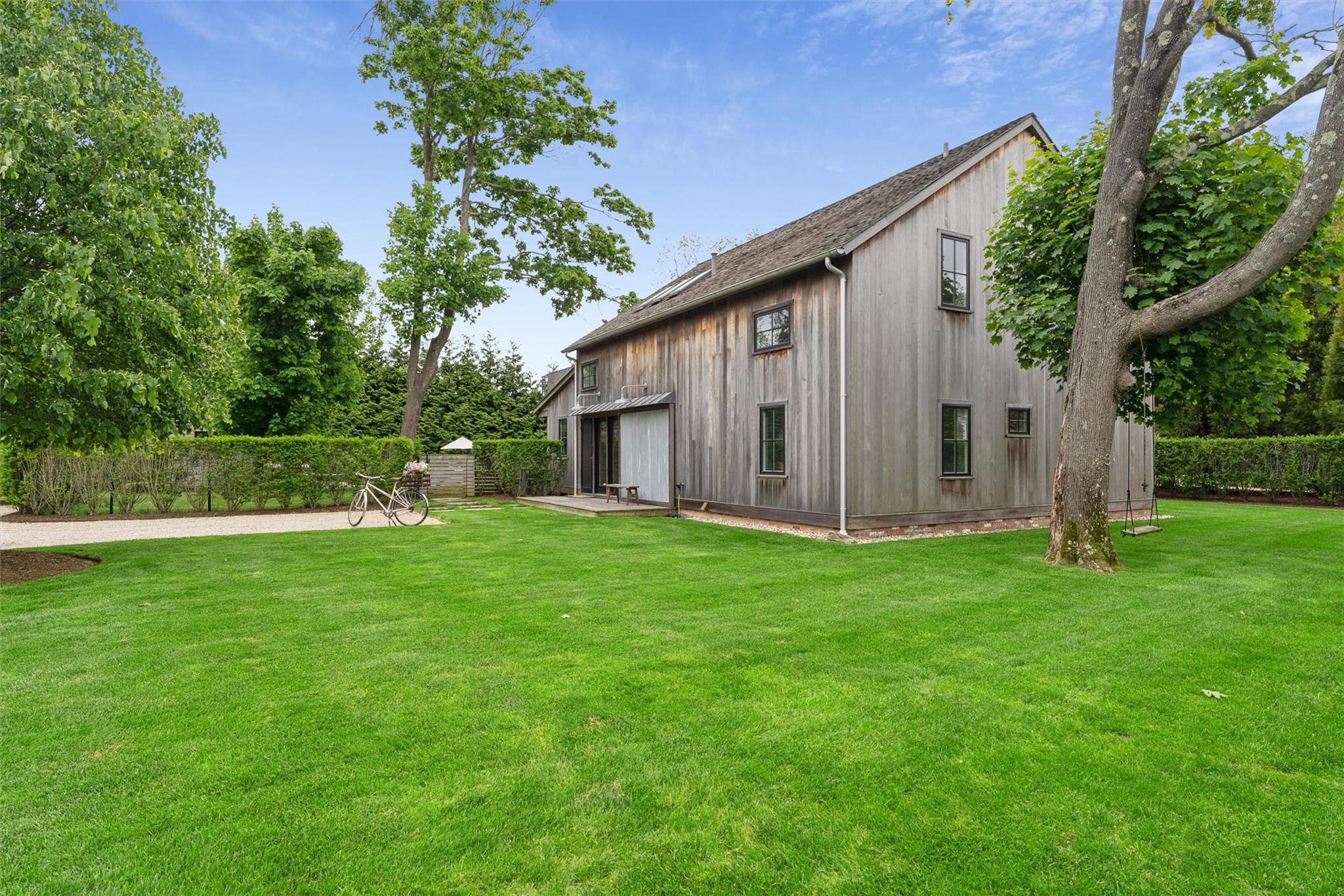 3 Pheasant Lane Remsenburg, NY 11960 - Photo 1 of 1 a view of a backyard with potted plants and large trees