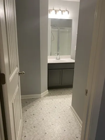 a view of bathroom with a sink and mirror
