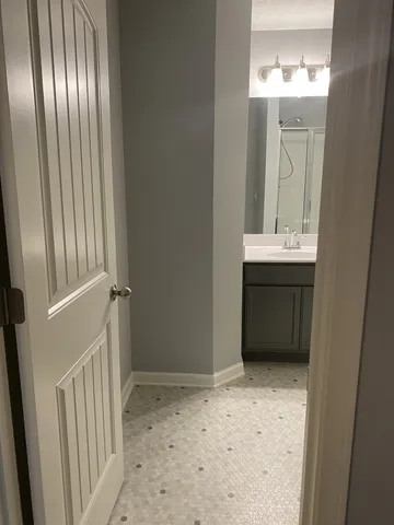 a bathroom with a glass shower door and a shower