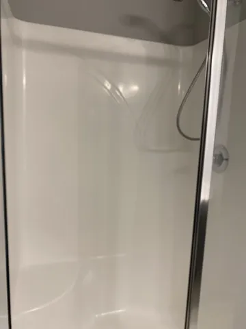 a bathroom with a glass shower door