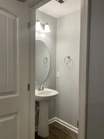 a bathroom with a sink toilet and mirror