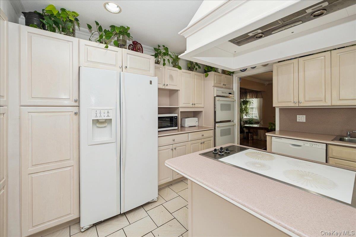 346 Ridgefield Road Hauppauge, NY 11788 - Photo 22 of 45 Kitchen with premium range hood, white appliances, light countertops, cream cabinets, and recessed lighting