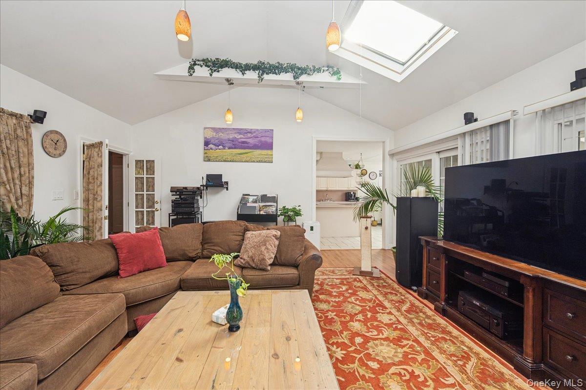 346 Ridgefield Road Hauppauge, NY 11788 - Photo 29 of 45 Living room with a skylight, lofted ceiling, and wood finished floors