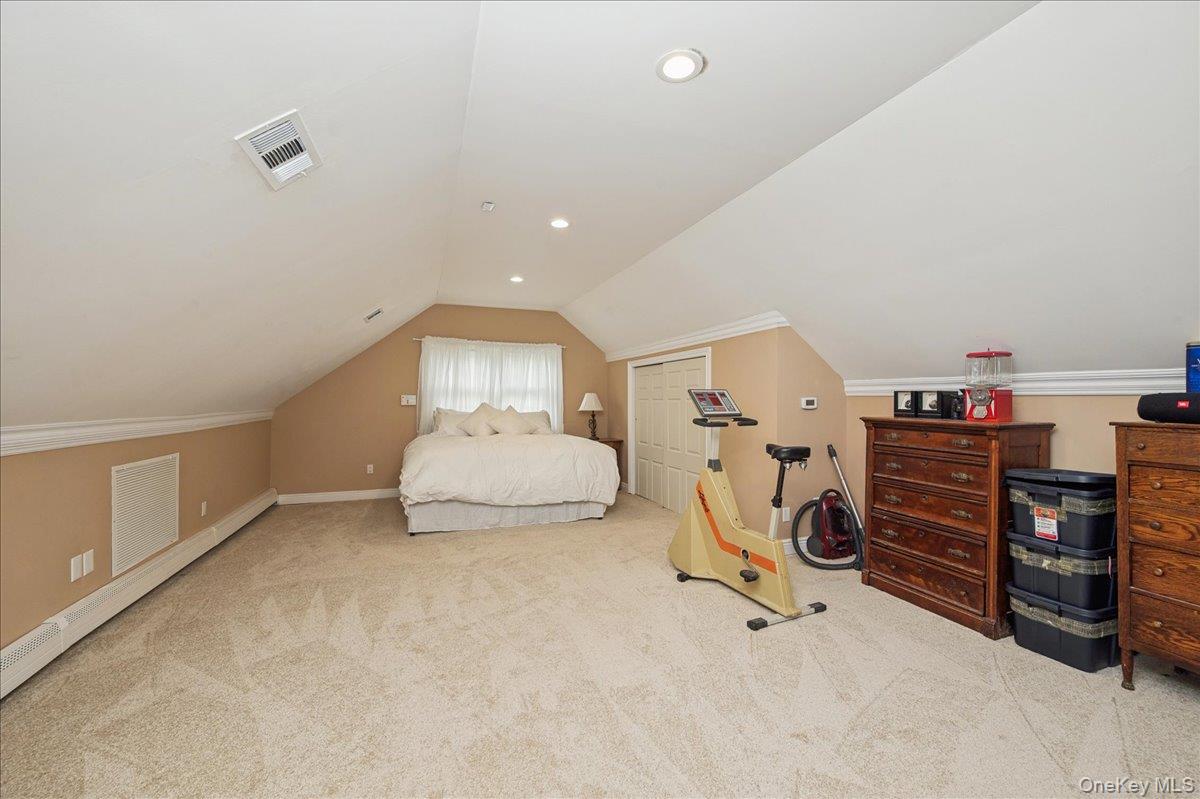 346 Ridgefield Road Hauppauge, NY 11788 - Photo 31 of 45 Carpeted bedroom featuring vaulted ceiling, baseboard heating, recessed lighting, and a closet