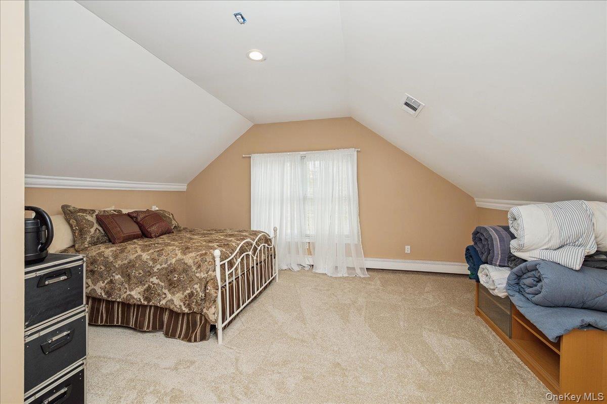 346 Ridgefield Road Hauppauge, NY 11788 - Photo 32 of 45 Bedroom with light carpet and vaulted ceiling