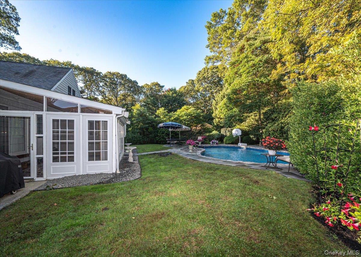 346 Ridgefield Road Hauppauge, NY 11788 - Photo 35 of 45 View of grassy yard with an outdoor pool, a patio, and view of scattered trees