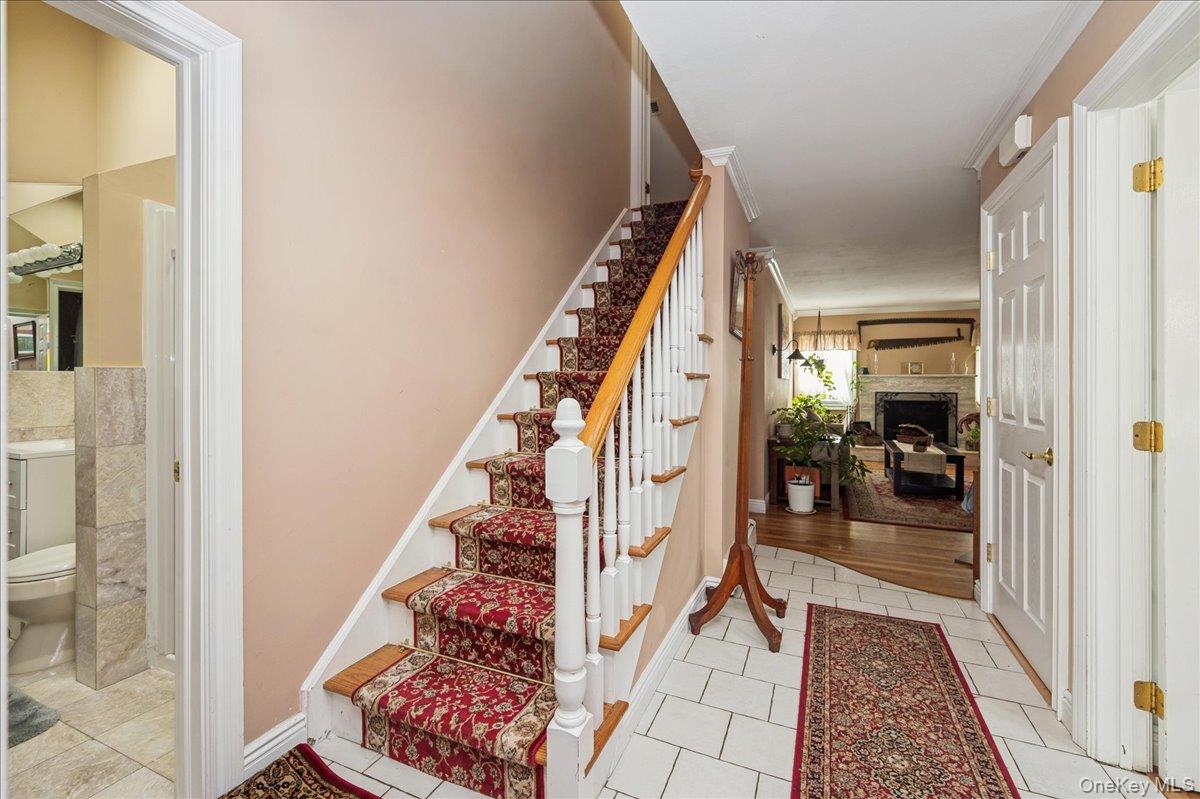 346 Ridgefield Road Hauppauge, NY 11788 - Photo 5 of 45 Stairs featuring tile patterned flooring and a fireplace