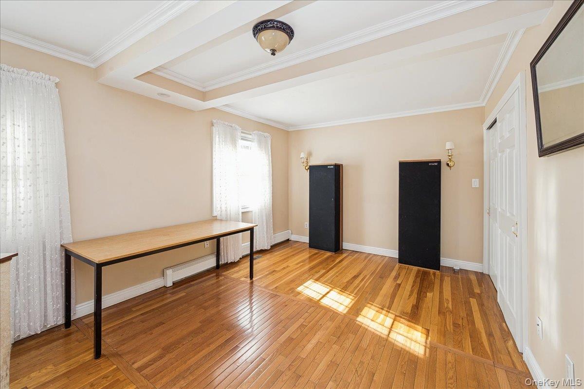 346 Ridgefield Road Hauppauge, NY 11788 - Photo 8 of 45 Unfurnished bedroom with light wood finished floors, crown molding, and a closet