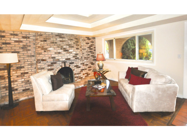 131 Hazel Avenue Millbrae, CA 94030 - Photo 2 of 16 a living room with a couch and a floor to ceiling window