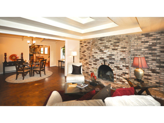 131 Hazel Avenue Millbrae, CA 94030 - Photo 3 of 16 a living room with fireplace furniture and a floor to ceiling window