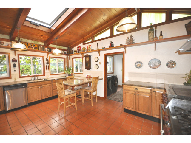 131 Hazel Avenue Millbrae, CA 94030 - Photo 6 of 16 a kitchen with stainless steel appliances granite countertop a stove a refrigerator a dining table and chairs with wooden floor