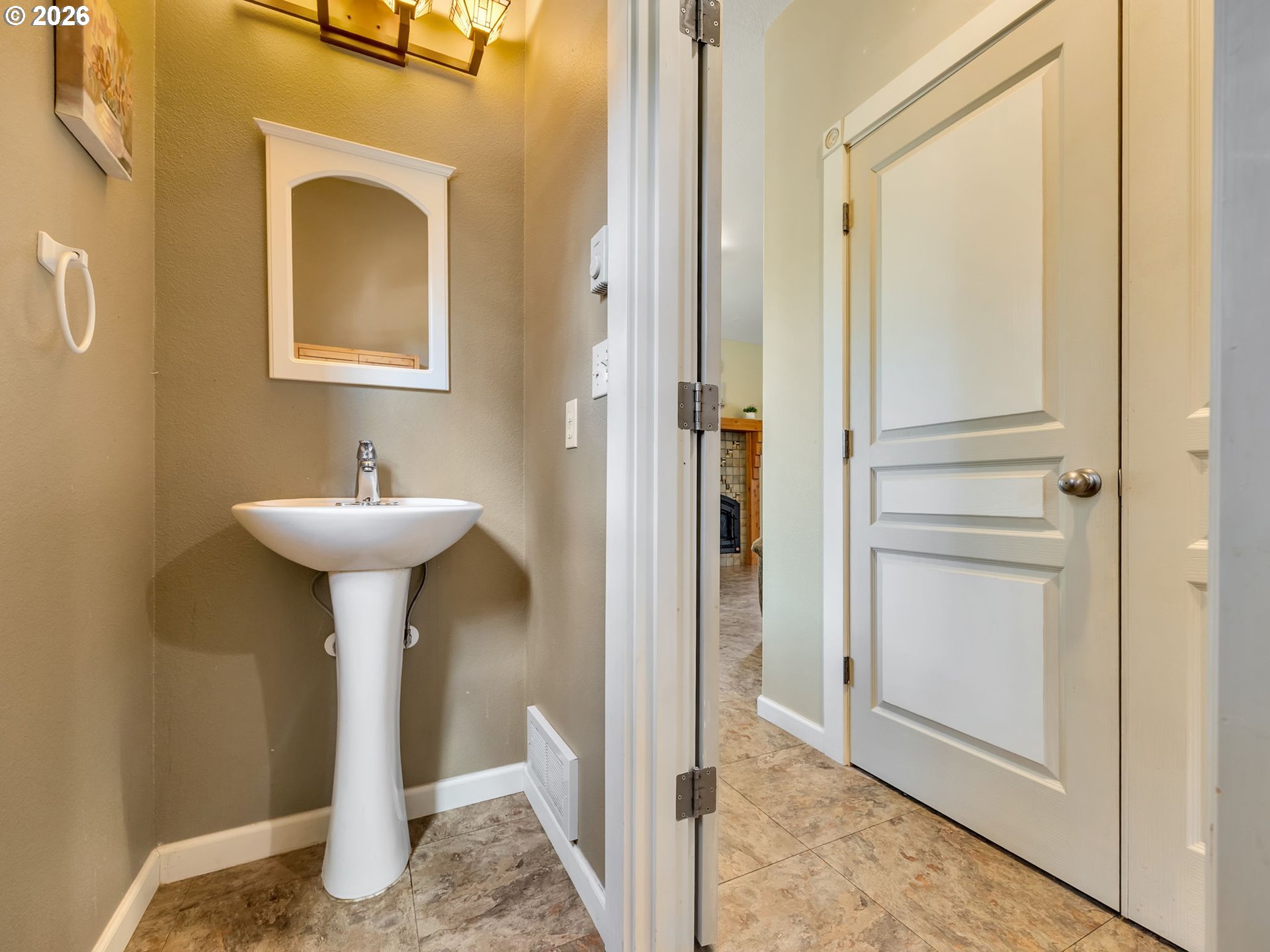 1077 Southwest Ridge Road Warrenton, OR 97146 - Photo 16 of 46 a bathroom with a sink and a mirror