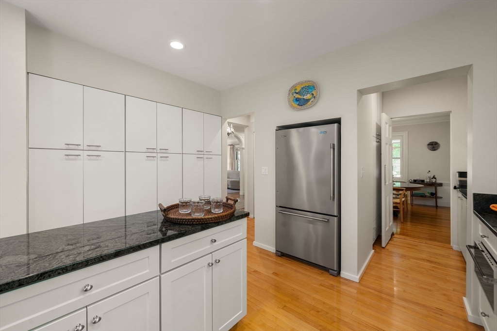 210 Upland Road Newton, MA 02460 - Photo 11 of 41 a kitchen with granite countertop a refrigerator and a sink