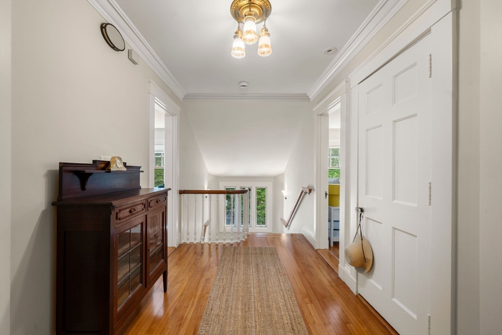 210 Upland Road Newton, MA 02460 - Photo 16 of 41 a view of a hallway with wooden floor and staircase