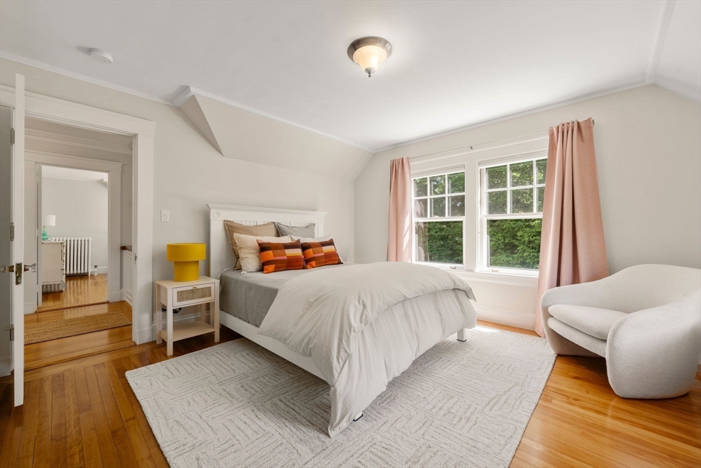 210 Upland Road Newton, MA 02460 - Photo 20 of 41 a bed room with a bed and a couch