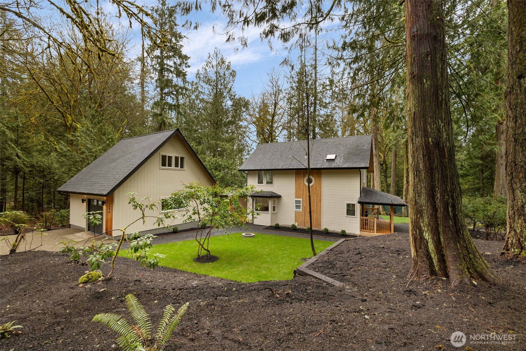 120 East Stadium Lane Grapeview, WA 98546 - Photo 21 of 34 a front view of a house with a yard and large tree