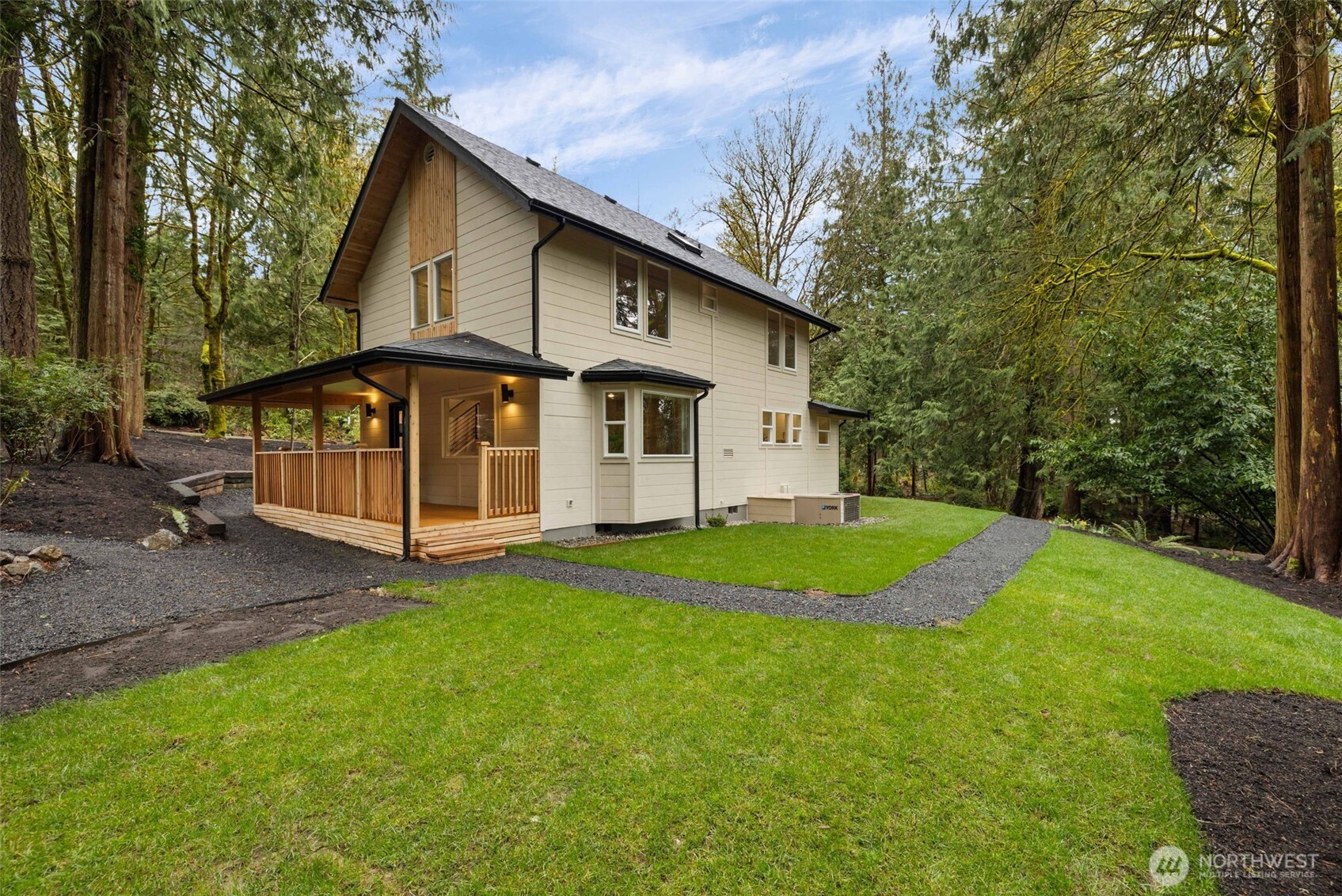 120 East Stadium Lane Grapeview, WA 98546 - Photo 27 of 34 a view of a white house with a big yard potted plants and large tree