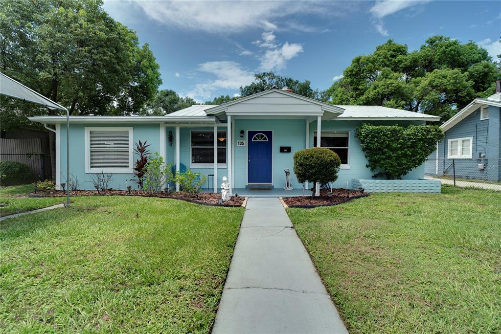 135 East Story Road Winter Garden, FL 34787 - Photo 1 of 1 a front view of a house with a yard and potted plants