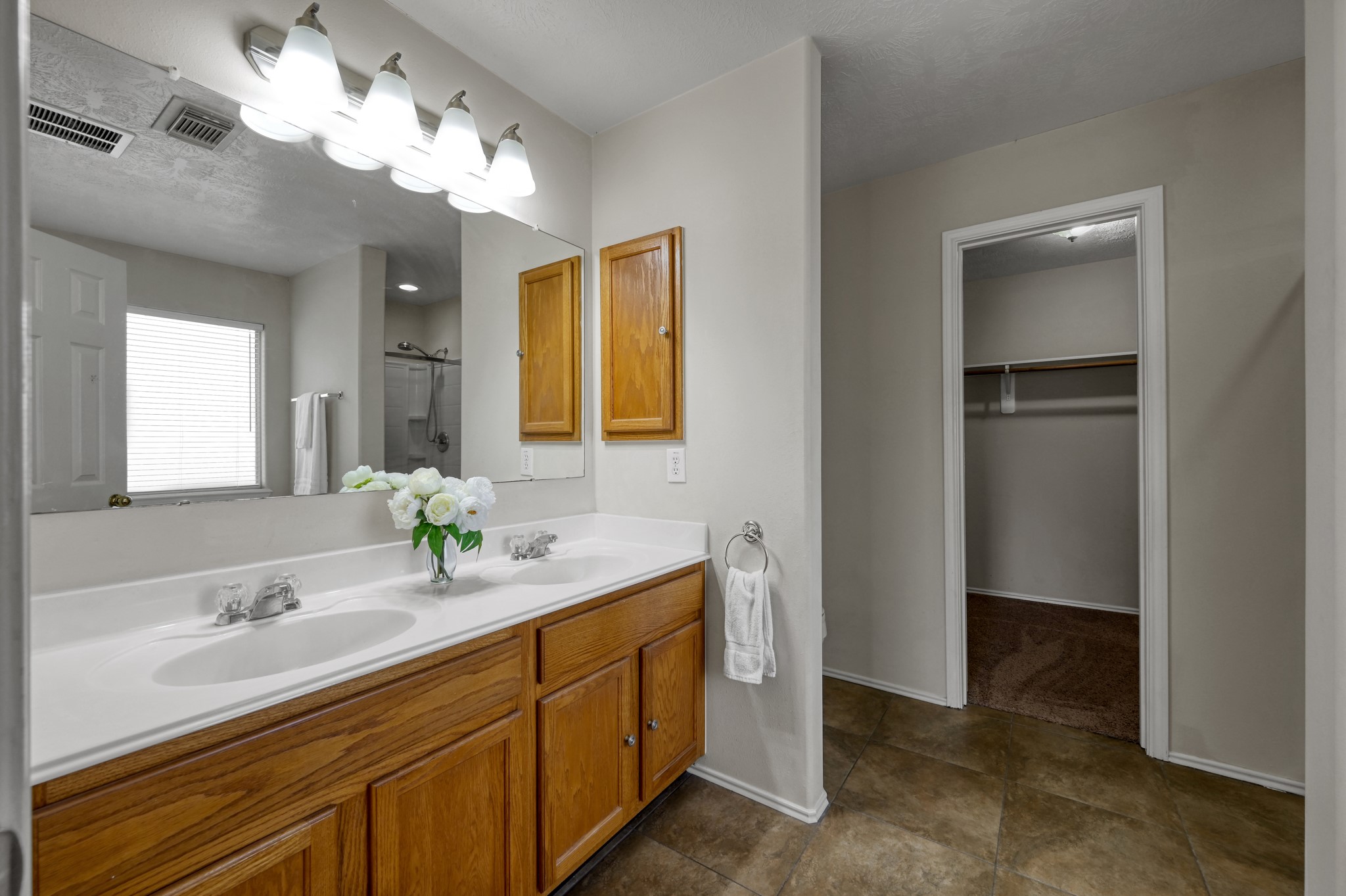 23919 Kingbriar Drive Spring, TX 77373 - Photo 25 of 33 The primary bath features dual sink vanities and a spacious layout designed for everyday comfort.