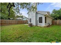 7705 Grovedale Trail Austin, TX 78729 - Photo 12 of 25 a view of a house with backyard and a tree
