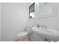 7705 Grovedale Trail Austin, TX 78729 - Photo 19 of 25 a bathroom with a sink a toilet and mirror