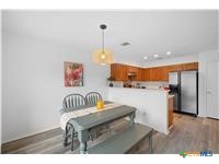 7705 Grovedale Trail Austin, TX 78729 - Photo 20 of 25 a view of kitchen with furniture and wooden floor