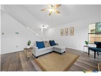 7705 Grovedale Trail Austin, TX 78729 - Photo 2 of 25 a living room with furniture and a wooden floor