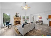 7705 Grovedale Trail Austin, TX 78729 - Photo 21 of 25 a living room with furniture and a fireplace