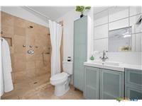 7705 Grovedale Trail Austin, TX 78729 - Photo 25 of 25 a bathroom with a granite countertop sink toilet and shower