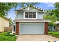 7705 Grovedale Trail Austin, TX 78729 - Photo 3 of 25 a front view of a house with a garden