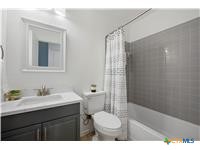 7705 Grovedale Trail Austin, TX 78729 - Photo 7 of 25 a bathroom with a sink toilet a mirror and shower