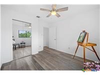 7705 Grovedale Trail Austin, TX 78729 - Photo 8 of 25 a living room with furniture and a wooden floor