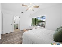 7705 Grovedale Trail Austin, TX 78729 - Photo 10 of 25 a bedroom with a bed and a window