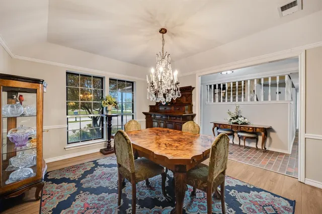 a dining room with furniture window and wooden floor